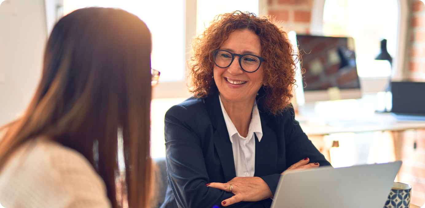 Smiling manager having a conversation with team member, reflecting the importance of communicating frontline change effectively