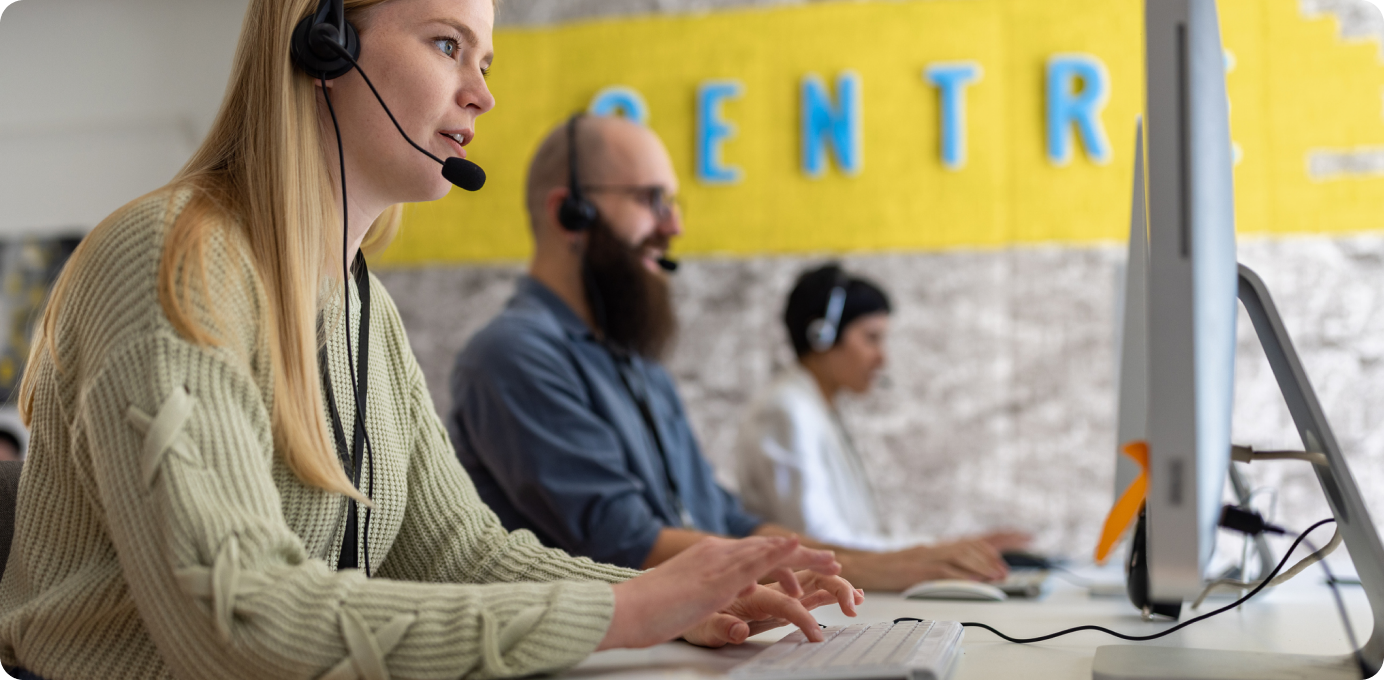 Contact center agents working at computers, illustrating how frontline enablement drives stronger CX results and ROI.