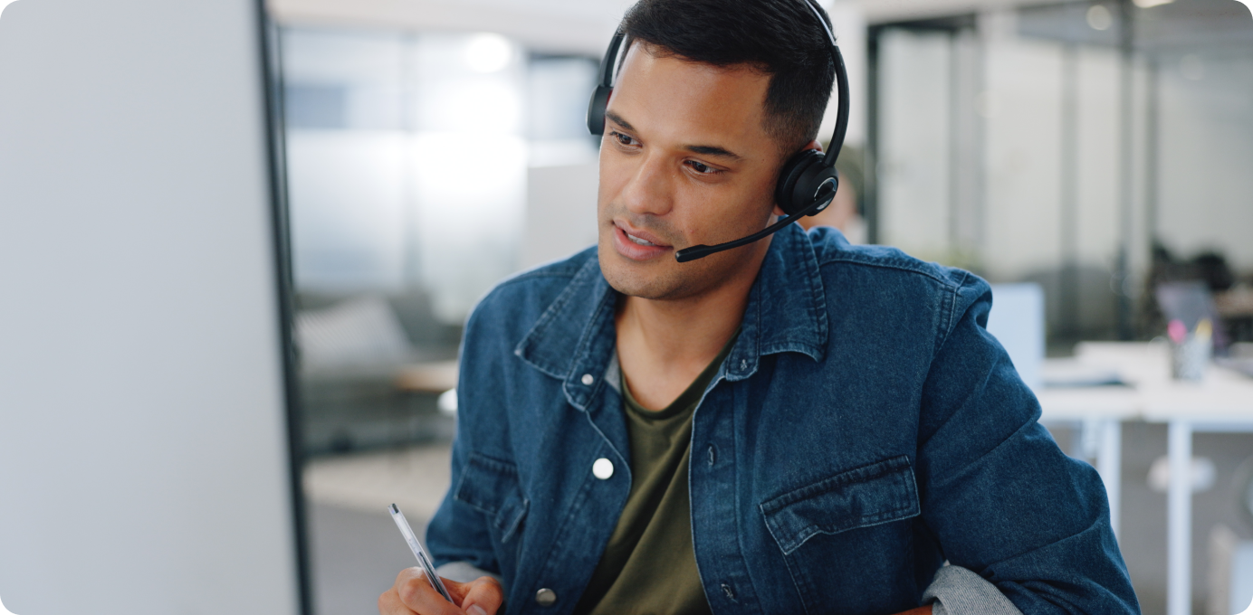 Contact center employee with headset discussing growth opportunities, highlighting the role of career path transparency in developing higher-value skills.