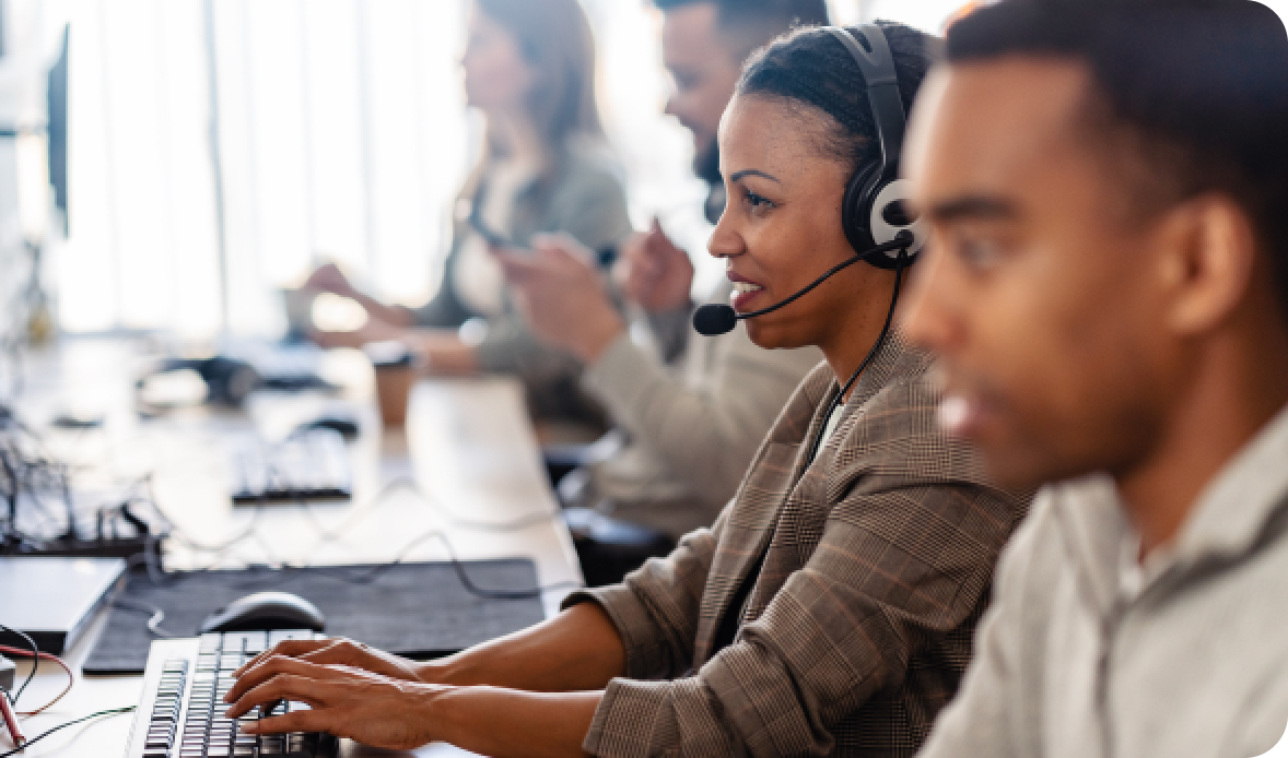 Focused call center agents using headsets and computers, showing AI’s role in improving agent experience in call centers